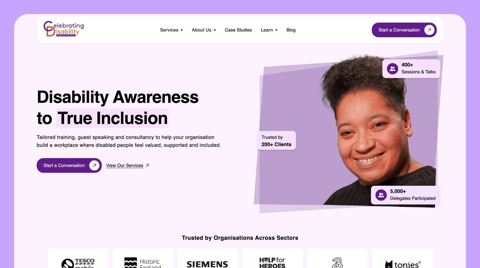 Celebrating Disability homepage, with a white navigation, Esi smiling to the right of the text Disability Awareness to True Inclusion