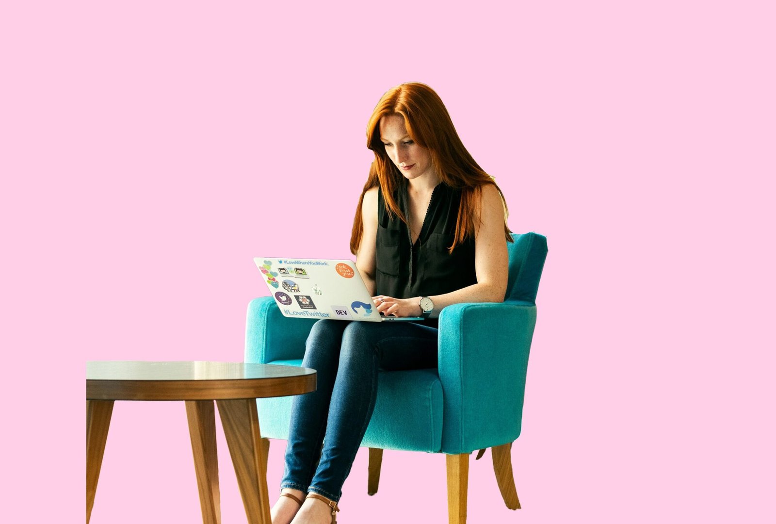 Gloucester business women sat on a blue chair with a laptop on her lap