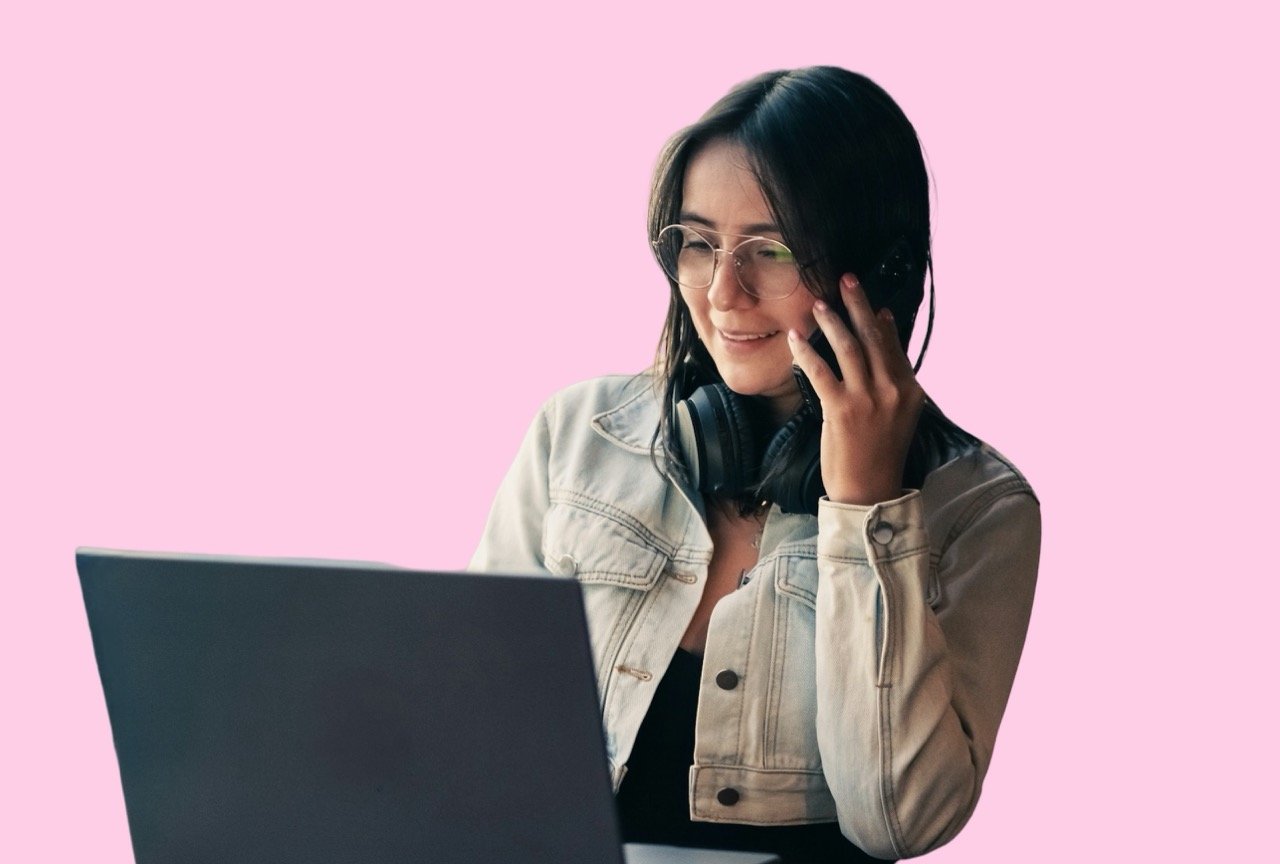Woman speaking on the phone while using a laptop for an Oxford website project.