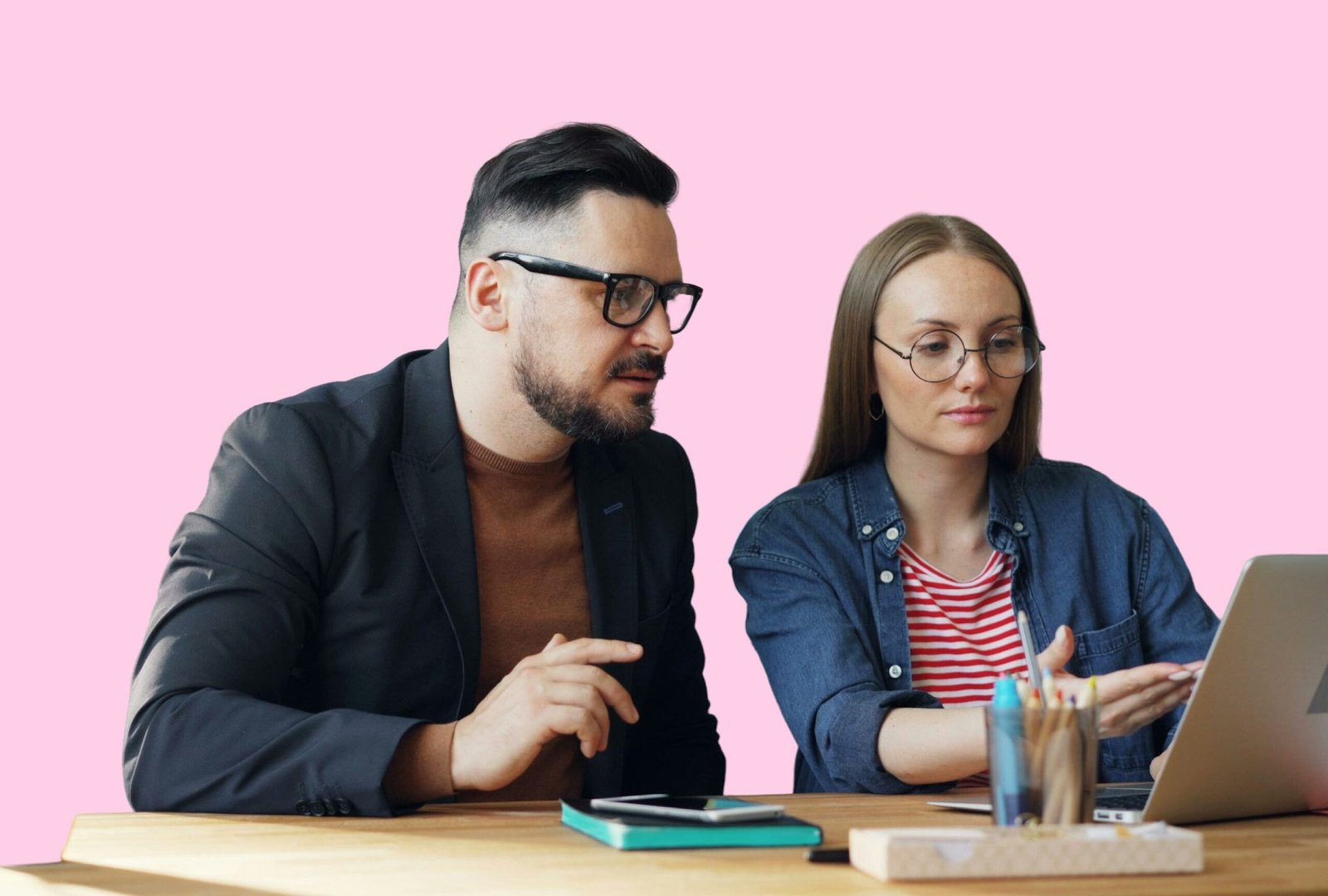 Two people reviewing a laptop during an Oxford website project.