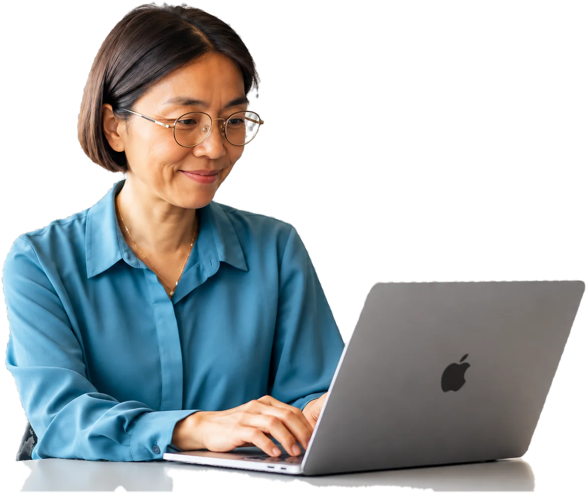 Woman in glasses smiling as she types on a laptop